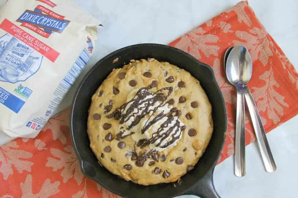 This Chocolate Chip Pumpkin Skillet Cookie is so much easier to make then a batch of cookies! It's super easy to make and perfect for fall! Chocolate Chip Pumpkin Skillet Cookie in skillet on orange napkin