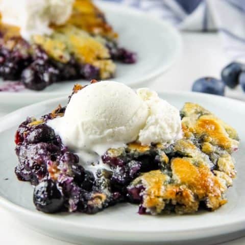 Blueberry Cobbler on white plate with ice cream