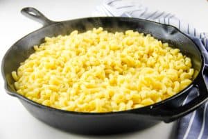 Cheesy Macaroni Pasta Bake with cooked noodles in skillet
