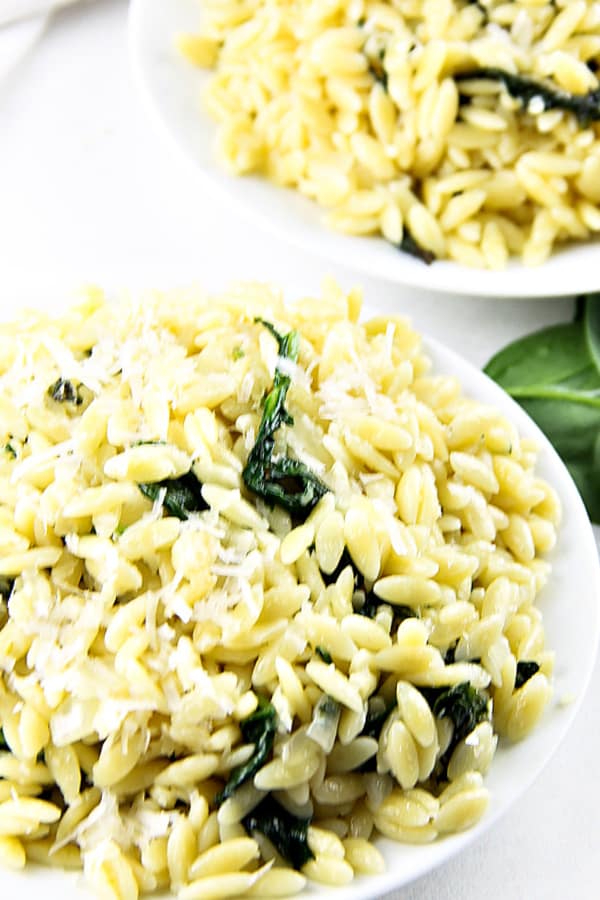 This Cheesy Spinach Orzo is an easy 20 minute meal! Made with fresh spinach, onions and garlic this tasty pasta is also loaded with freshly grated cheese!