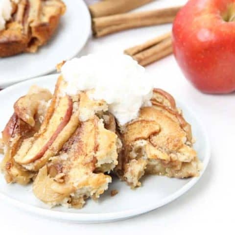 Easy Apple Cobbler on white plate with ice cream on top.