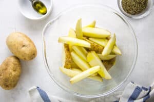 potatoes in bowl with olive oil.