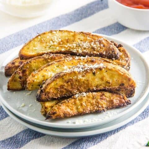 Air Fryer Parmesan Potato Wedges on white plate.