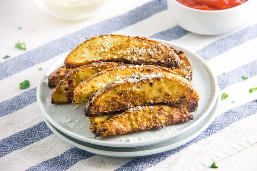 Air Fryer Parmesan Potato Wedges on white plate.