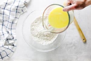 pouring butter mixture in bowl.