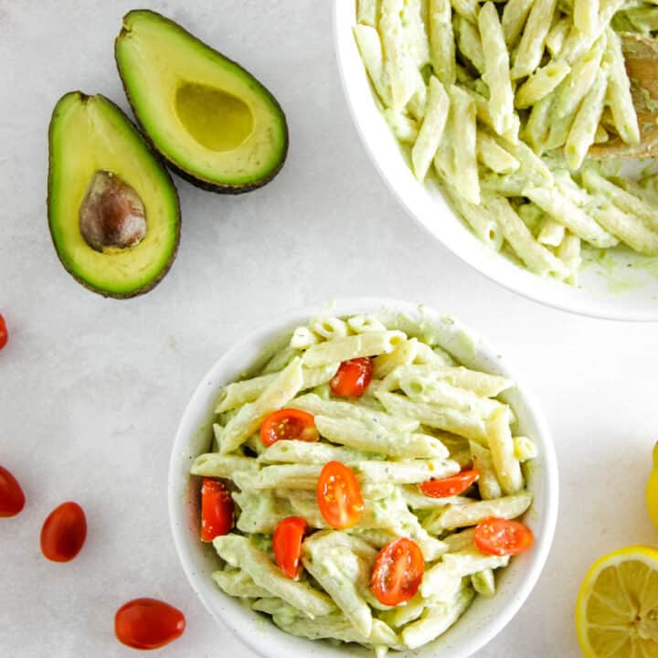 overhead view of creamy avocado pasta in bowl.