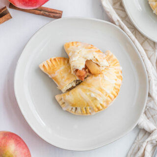 cooked turnovers on white plate.