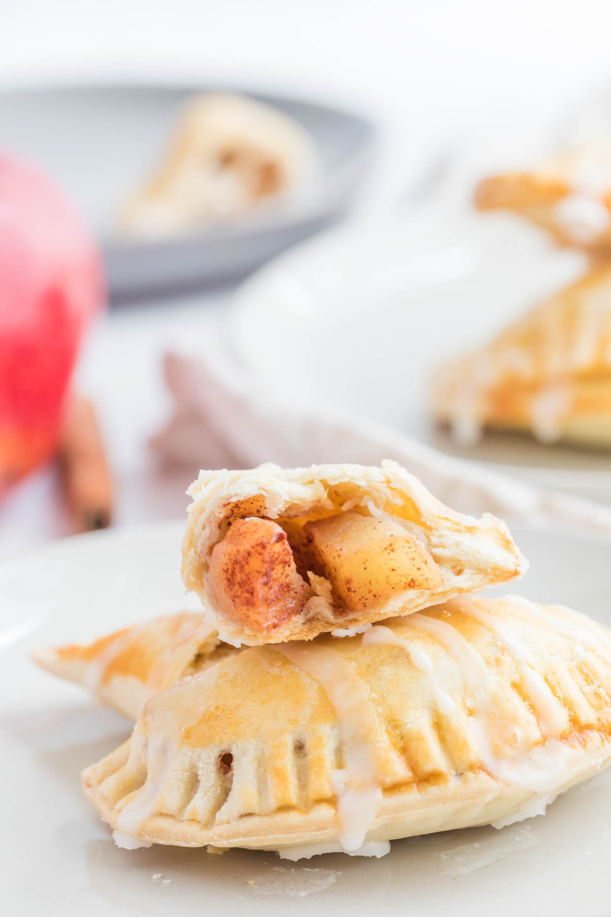 Homemade buttery pie crust filled with a delicious simple apple compote makes these Apple Pie Turnovers a new family favorite! Apple Pie Turnovers cut in half.