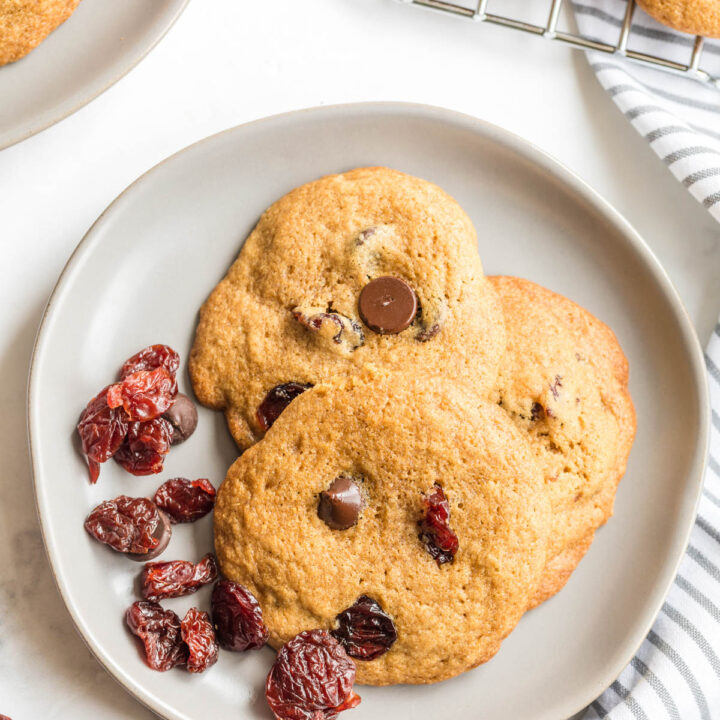 Dark Chocolate Chip Cherry Cookies on plate with dried cherries.