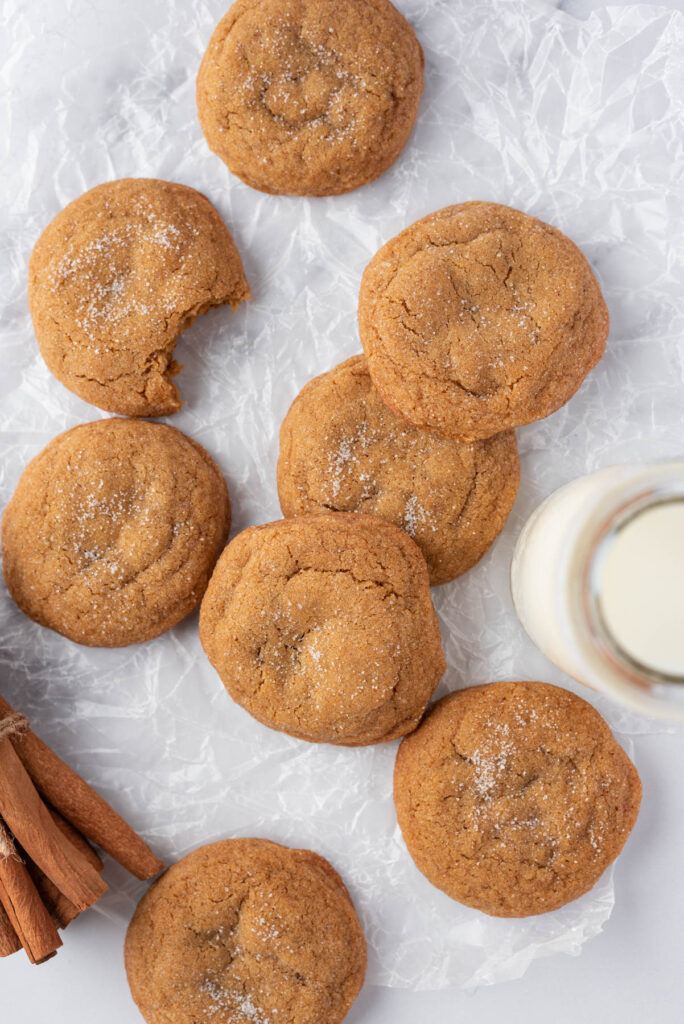 Soft and fluffy Ginger Molasses Cookies! WIth a delicious flavor these will be your new, favorite classic cookie to make! Ginger Molasses Cookies on parchment paper.