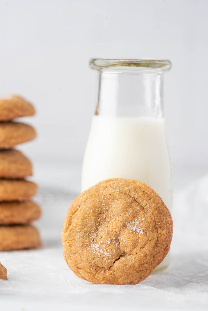 Soft and fluffy Ginger Molasses Cookies! WIth a delicious flavor these will be your new, favorite classic cookie to make! Ginger Molasses Cookies on white background with milk.