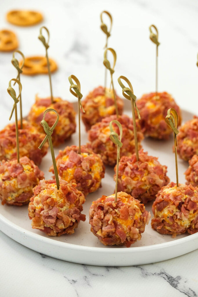 These Mini Bacon Ranch Cheeseballs are perfect for snacking! Made with cream cheese, ranch dressing and bacon bits! Mini Bacon Ranch Cheeseballs on white plate.