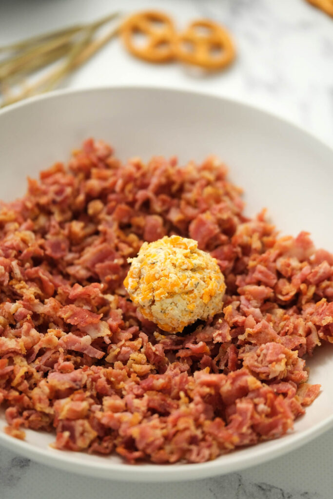 rolling ball in bacon bits.