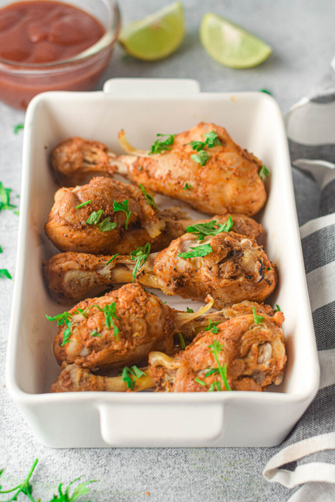 Instant Pot Chicken Drumsticks are so juicy and tender and can be made in no time. Perfectly seasoned and cooked to perfection Instant Pot Chicken Drumsticks in white casserole dish.