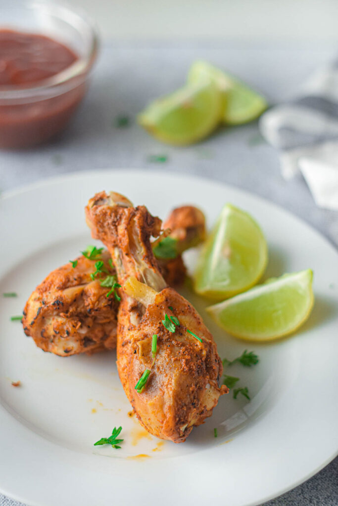 Instant Pot Chicken Drumsticks are so juicy and tender and can be made in no time. Perfectly seasoned and cooked to perfection Instant Pot Chicken Drumsticks on white plate.