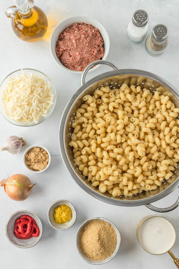 Sloppy Joe Pasta Casserole is perfect for busy weeknights when you want comfort food, minus the mess. Chock full of beef, noodles, and cheese! ingredients for sloppy joe pasta in white bowls.