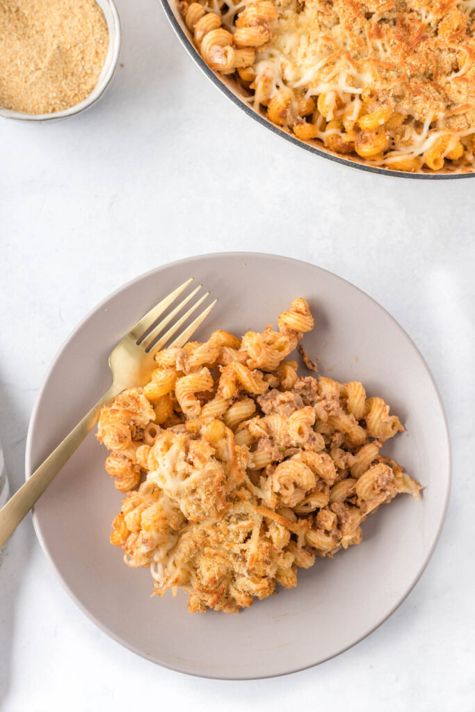 Sloppy Joe Pasta Casserole is perfect for busy weeknights when you want comfort food, minus the mess. Chock full of beef, noodles, and cheese! pasta casserole portion on plate with fork.