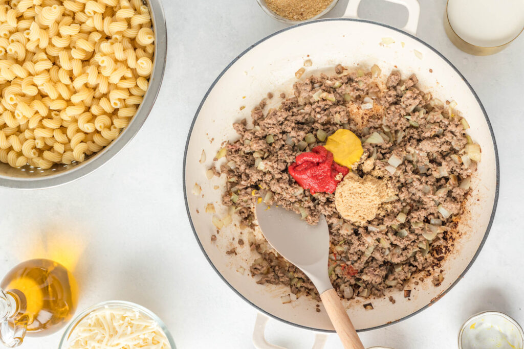 cooked beef with seasonings in pan.