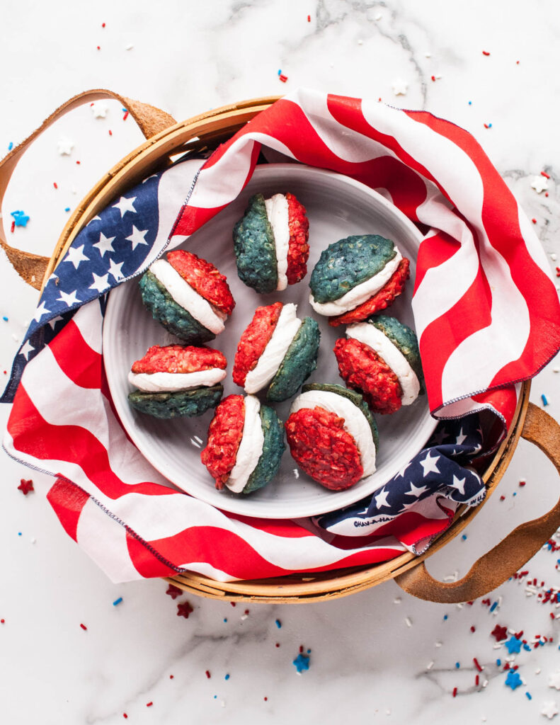These Oatmeal Cookie Sandwiches are a fun holiday treat! Soft, chewy cookie filled with a sweet buttercream frosting! Oatmeal Cookie Sandwiches wrapped in American flag.