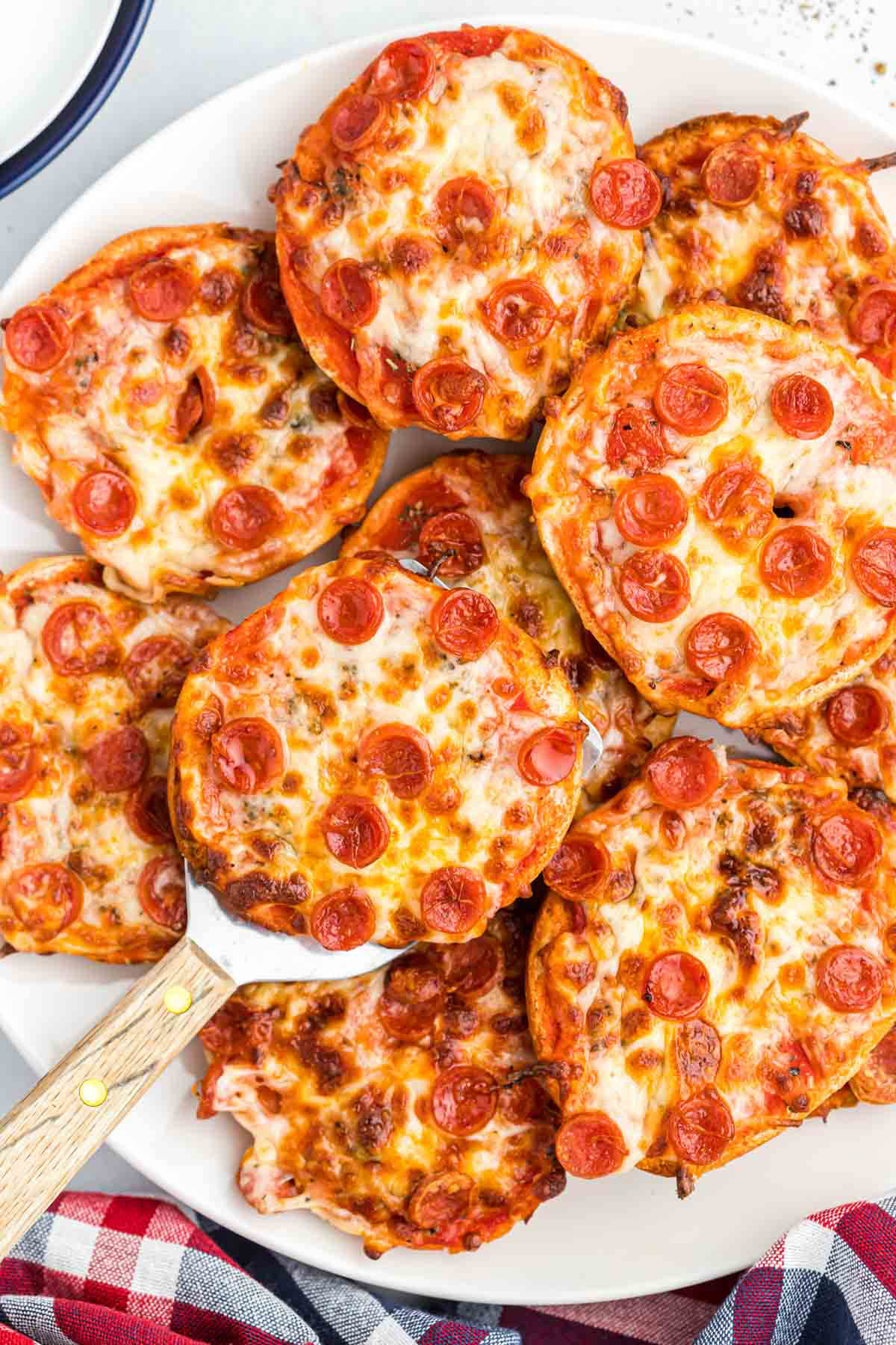 Easy Air Fryer Bagel Bites! These pizza flavored bites could not be easier! Made with a few ingredients that makes the best lunch or snack! Air Fryer Bagel Bites overhead view on spatula.