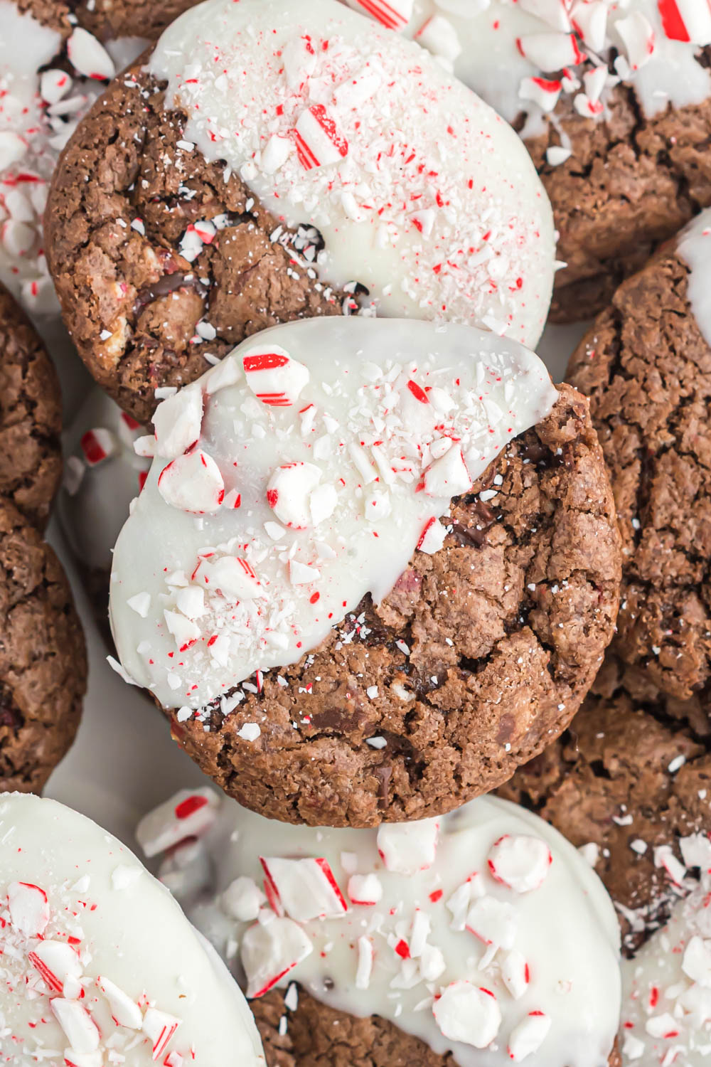 Easy chocolate peppermint bark cookies that are ready in no time! Full of peppermint flavor, these soft and gooey cookies are perfect! Chocolate Peppermint Bark Cookies dipped in white chocolate.