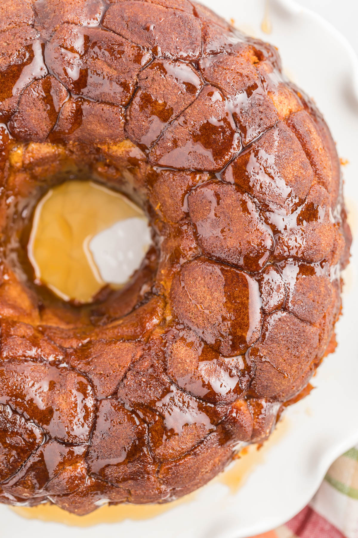 overhead view of pumpkin monkey bread topped with maple syrup