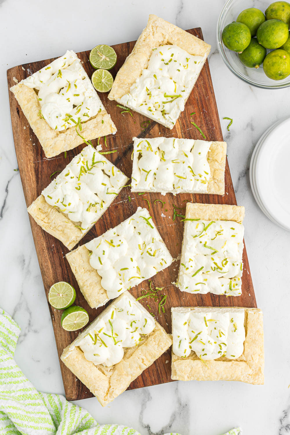 Overhead view of key lime tart cut into pieces.