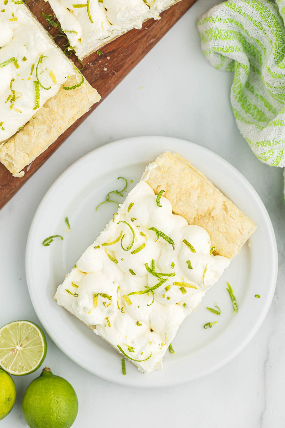Overhead view of key lime tart on white plate.
