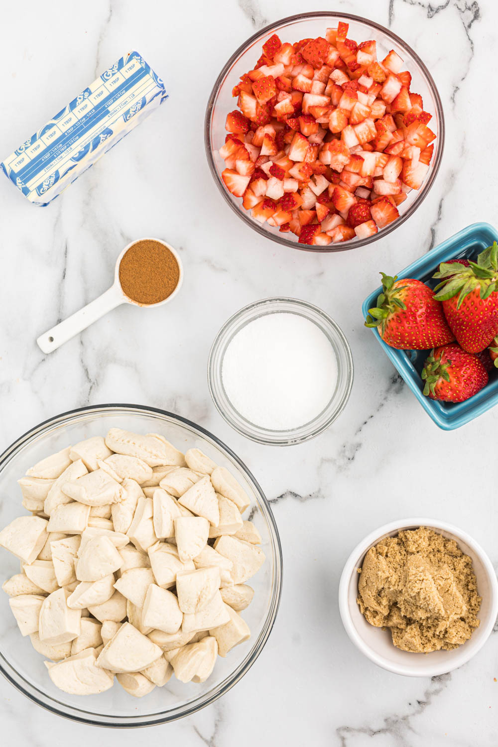 Ingredients for strawberry monkey bread in bowls.