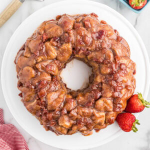 overhead view of strawberry monkey bread on white plate.