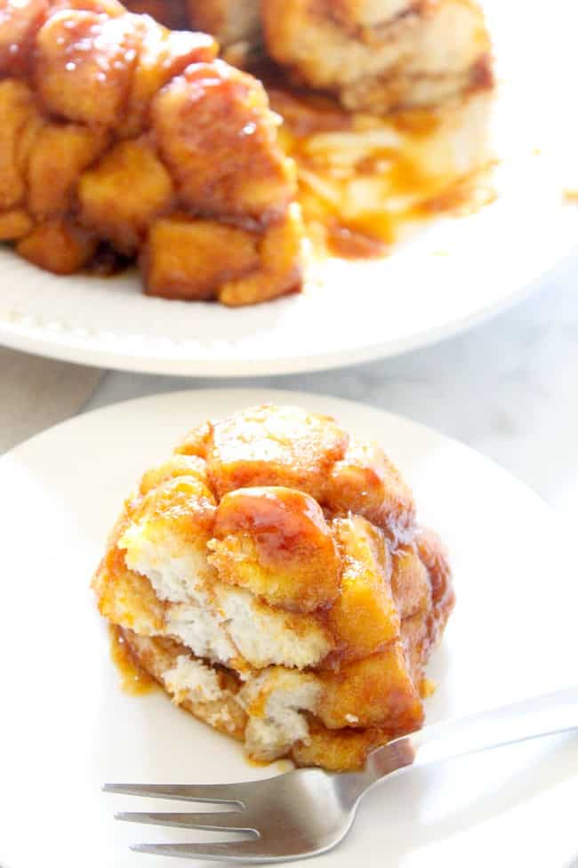 Maple Pumpkin Monkey Bread on white plate with fork