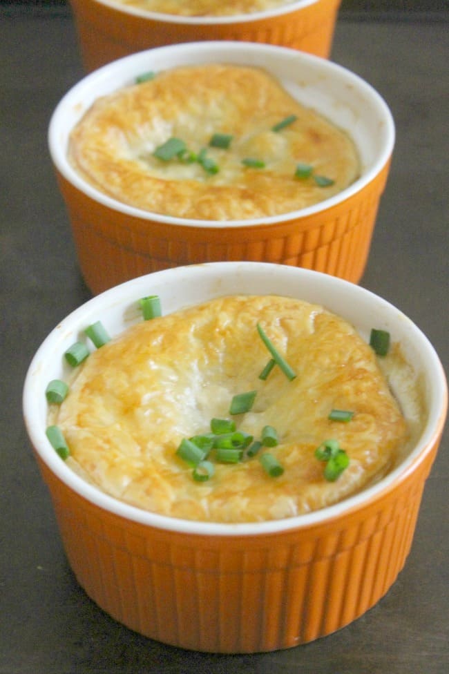 Leftover Turkey Puff Pastry Pot Pies in orange ramekins.