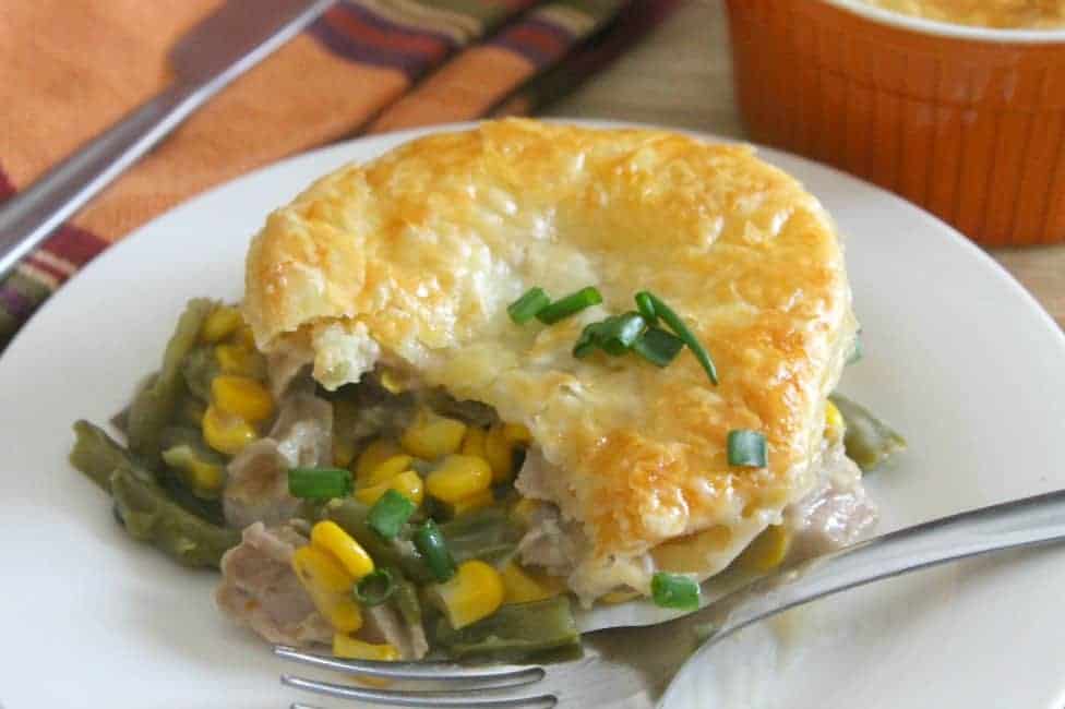 Leftover Turkey Puff Pastry Pot Pies on white plate with fork.