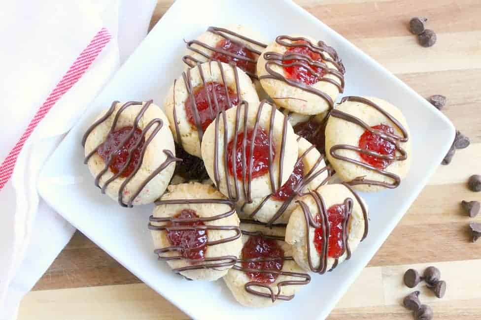 These Raspberry Chocolate Thumbprint Cookies are made with a simple cookie recipe filled with raspberry jam and drizzled with chocolate! The Bitter Side of Sweet #cookies #chocolate #raspberry Raspberry Chocolate Thumbprint Cookies | The Bitter Side of Sweet #raspberry #cookies #chocolate #helpingcookies