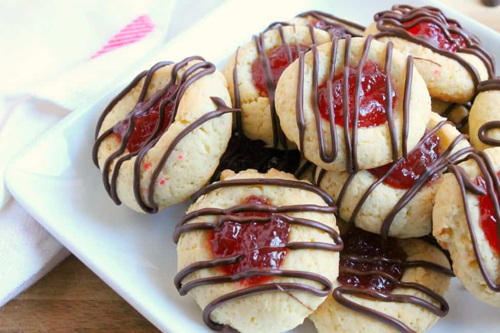 These Raspberry Chocolate Thumbprint Cookies are made with a simple cookie recipe filled with raspberry jam and drizzled with chocolate! The Bitter Side of Sweet #cookies #chocolate #raspberry Raspberry Chocolate Thumbprint Cookies | The Bitter Side of Sweet #raspberry #cookies #chocolate #helpingcookies