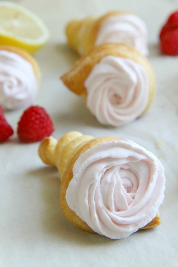 Lemon Raspberry Cream Horns on parchment paper