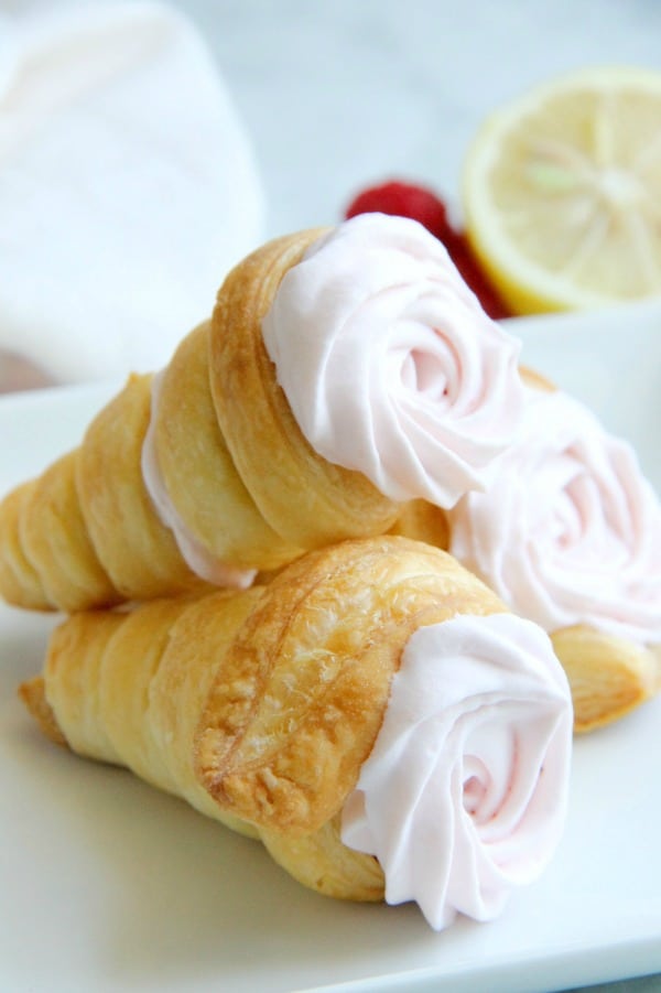 Lemon Raspberry Cream Horns stacked on white plate