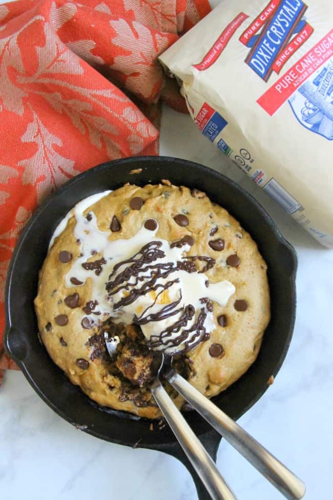 Chocolate Chip Pumpkin Skillet Cookie on white background in skillet with two spoons