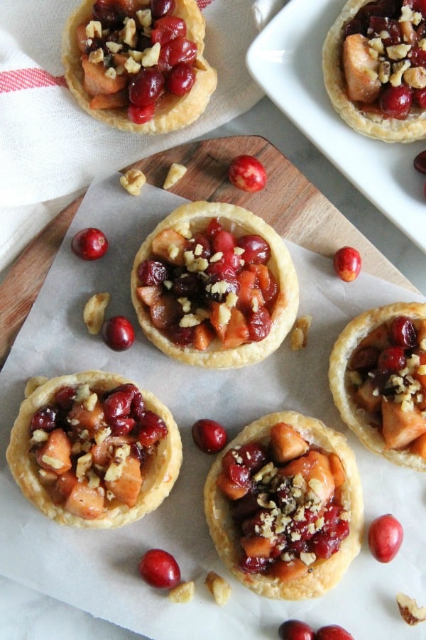 Cranberry Apple Walnut Tarts on brown board