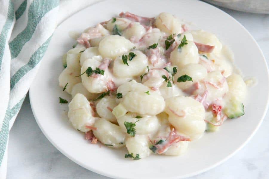 Creamy Gnocchi with Corned Beef and Zucchini on white plate