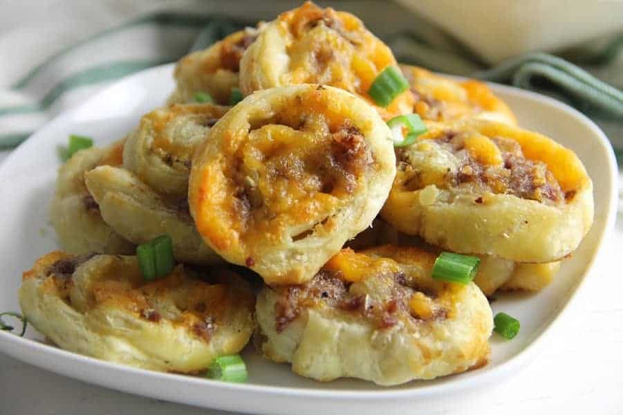 Puff Pastry Sausage Cheddar Pinwheels on white plate