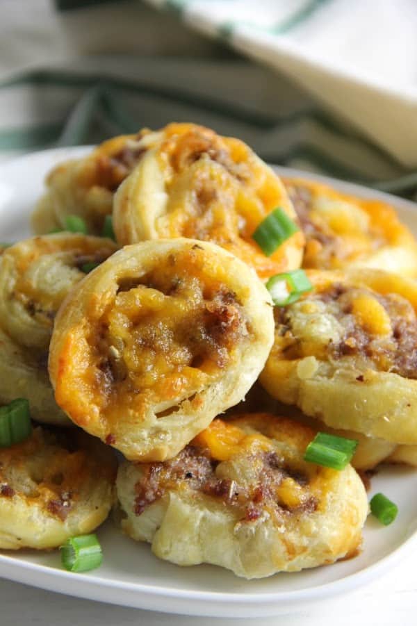 Puff Pastry Sausage Cheddar Pinwheels on white plate