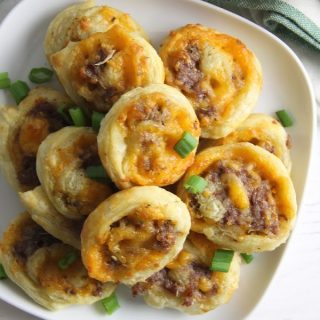 Puff Pastry Sausage Cheddar Pinwheels on white plate