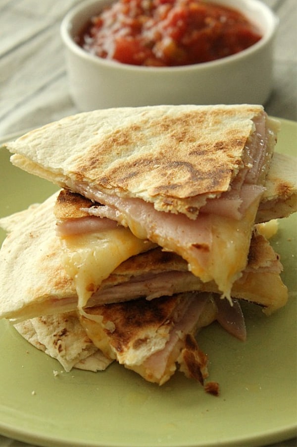 Ham and Cheese Quesadillas on stacked on green plate