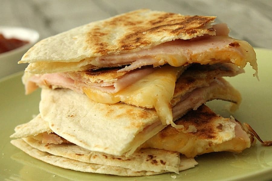 Ham and Cheese Quesadillas stacked on green plate