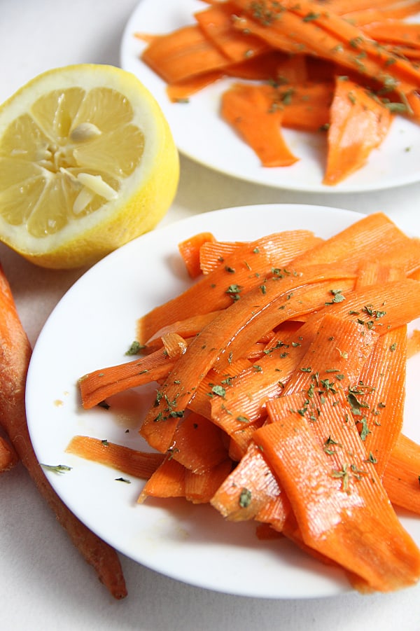 Lemon Carrot Salad on white plate topped with parsley