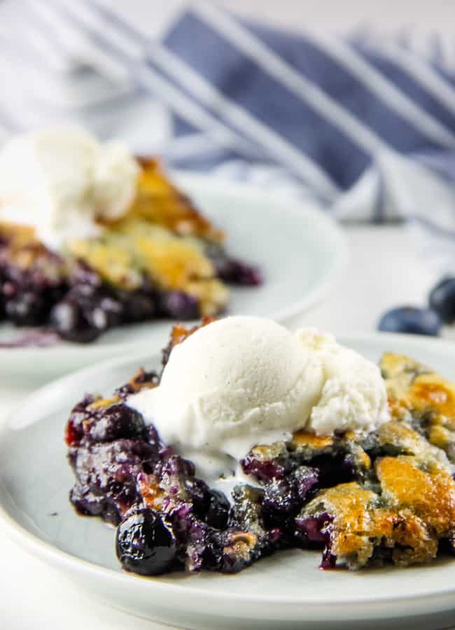Blueberry Cobbler on white plate with ice cream