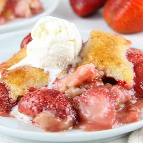 Strawberry Cobbler on white plate with ice cream