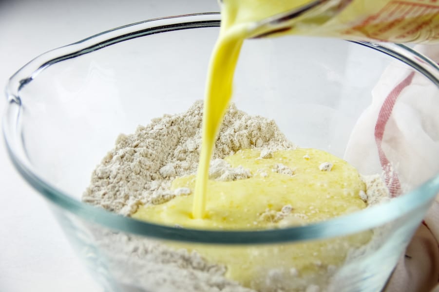 Strawberry Oatmeal Muffins, wet ingredients being poured into dry ingredients