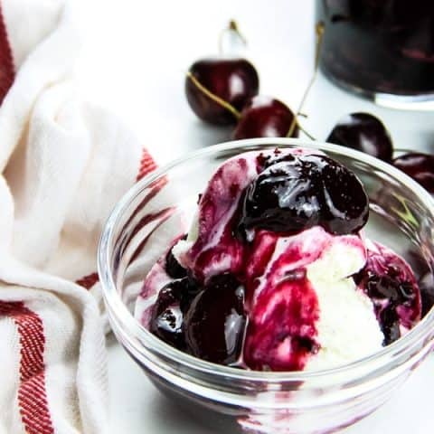 Easy Cherry Compote on ice cream in glass bowl